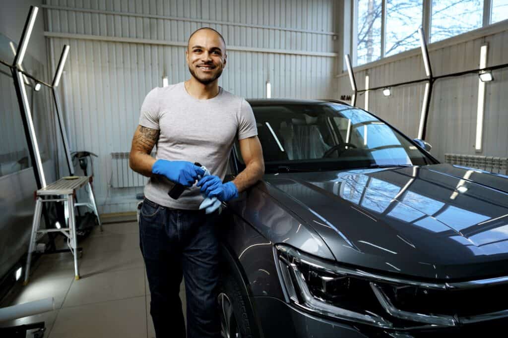 Portrait of African American man, car wash detailing service worker