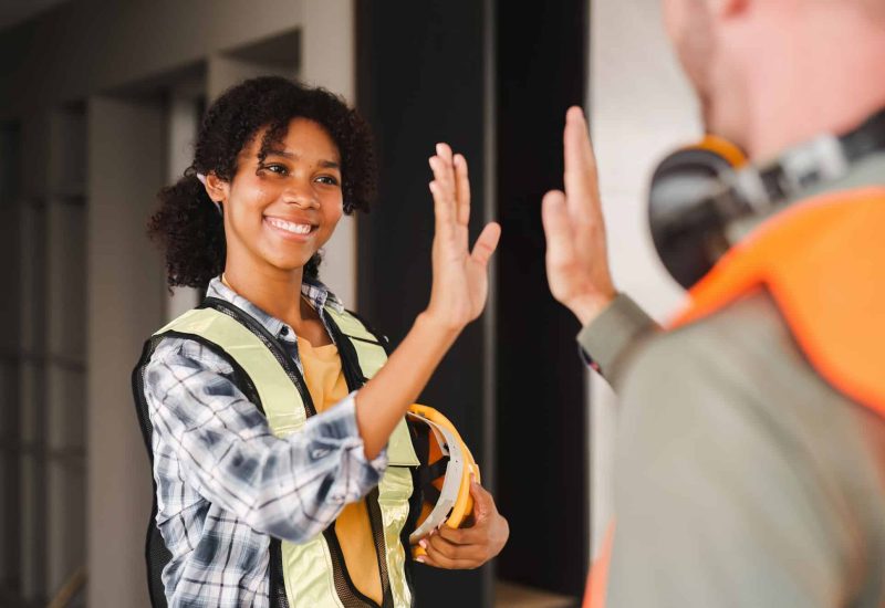 Foreman or Skillful worker team celebrate success at construction site. Industrial people and